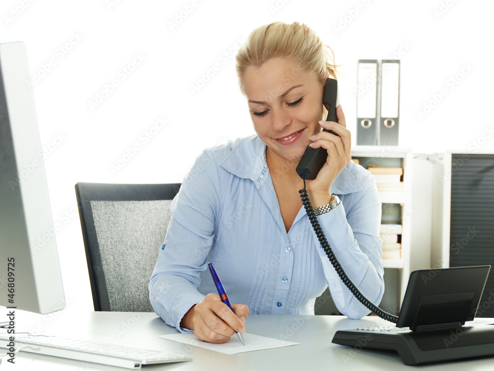 Pretty secretary makes notes while having a call at work Pretty secretary makes notes while having a call at work