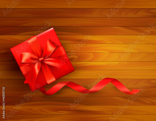 Holiday background with gift box and red bow.