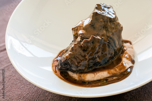 Appetizing roasted neef with dark gravy. photo