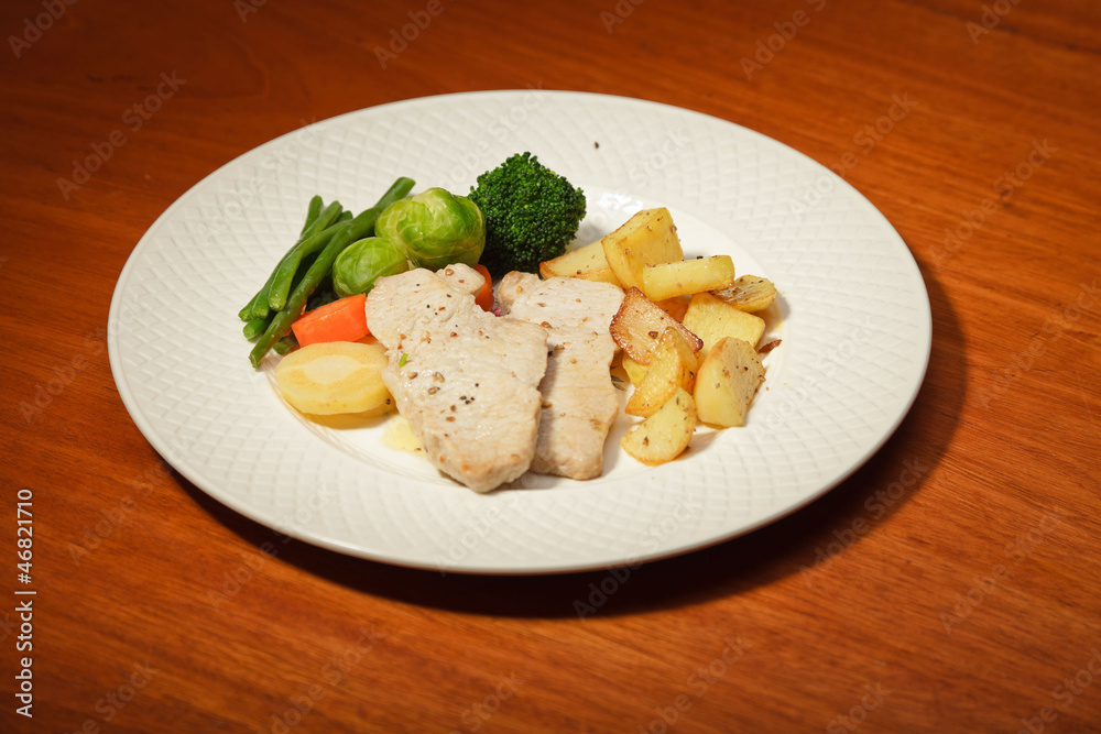 Dinner of vegetables potatoes and meat on a white plate. Dinner of vegetables potatoes and meat on a white plate.
