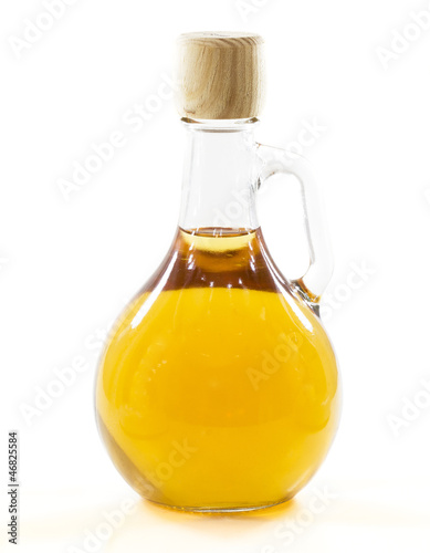 bottle with yellow liquid in a white background