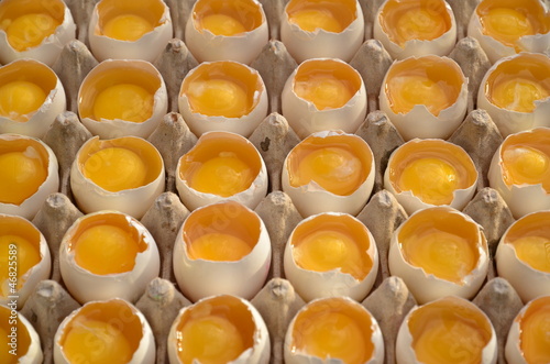 Opened eggs with visible yolk photo