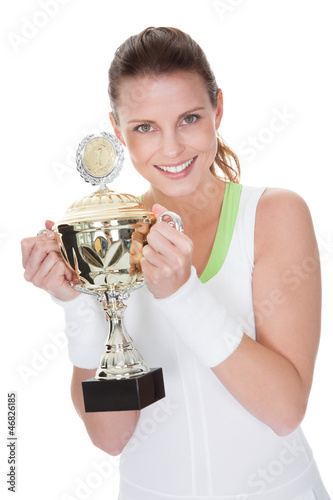 Jubilant winner holding up the trophy photo