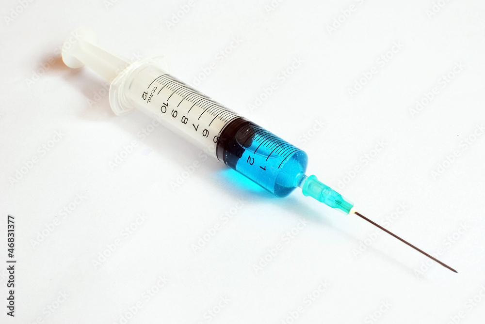 Syring with blue vaccine on white background Syring with blue vaccine on white background