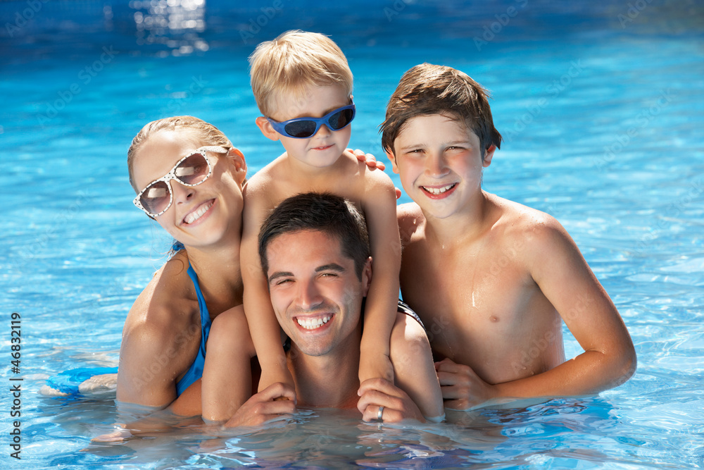 Family Having Fun In Swimming Pool Family Having Fun In Swimming Pool