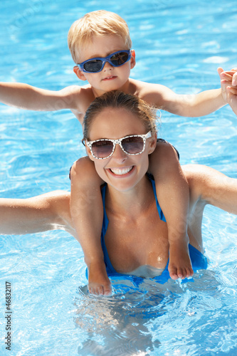 Mother And Son Having Fun In Swimming Pool
