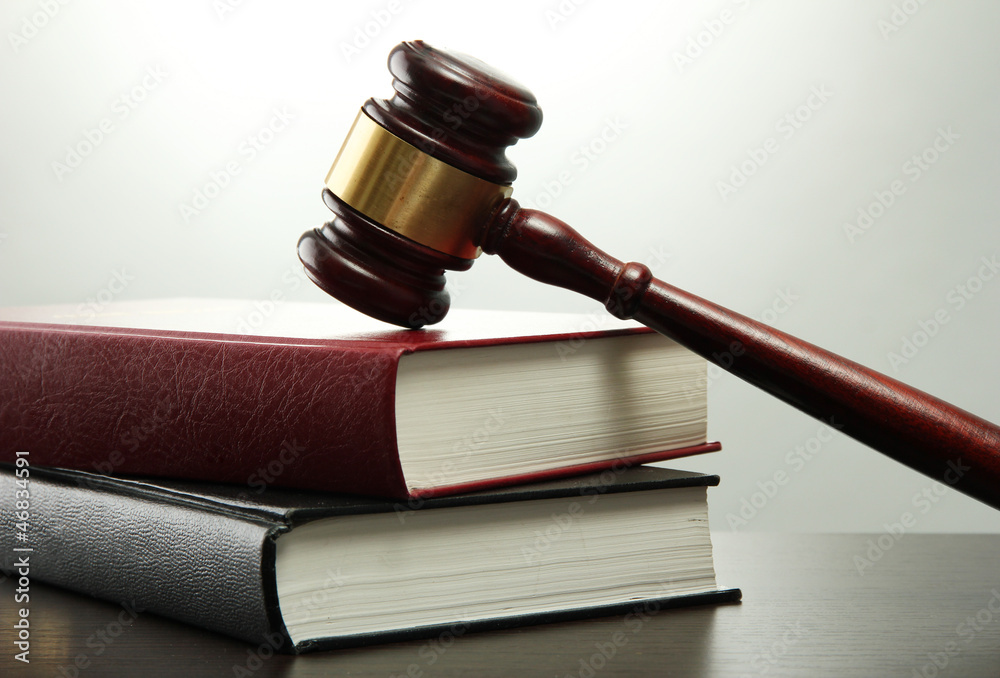 wooden gavel and books on wooden table,on grey background wooden gavel and books on wooden table,on grey background