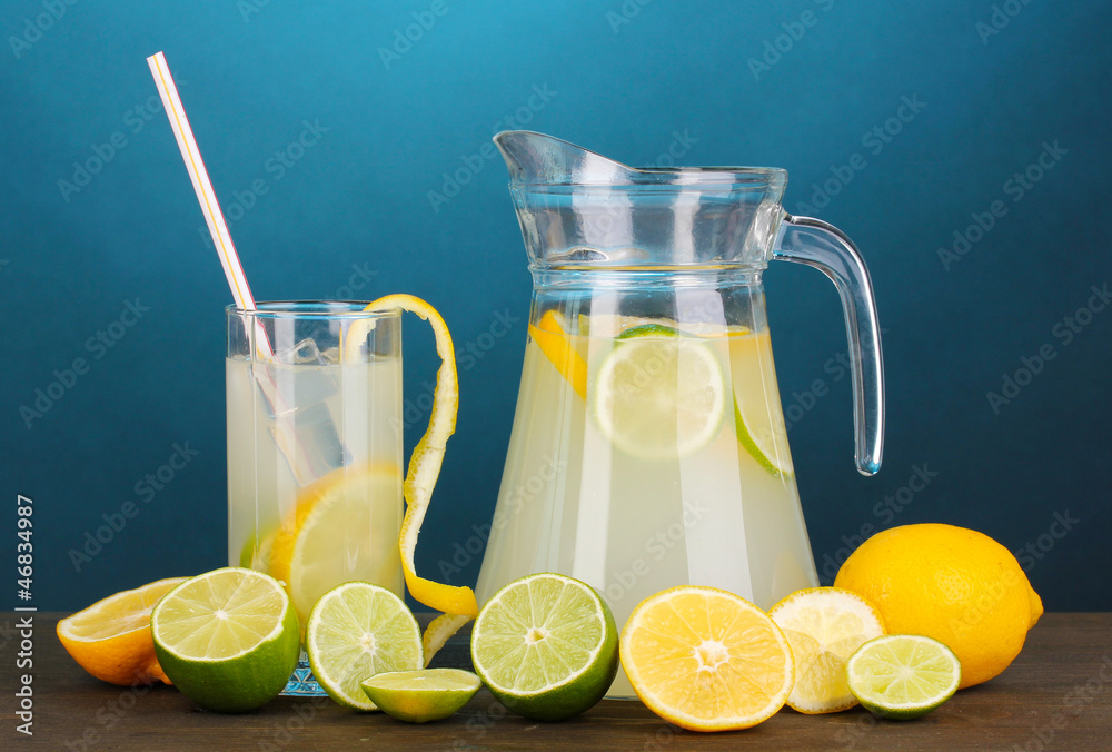 Citrus lemonade in pitcher and glass of citrus around