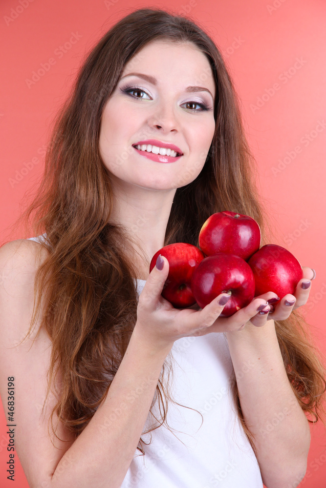 Beautiful woman with apples on pink background Beautiful woman with apples on pink background