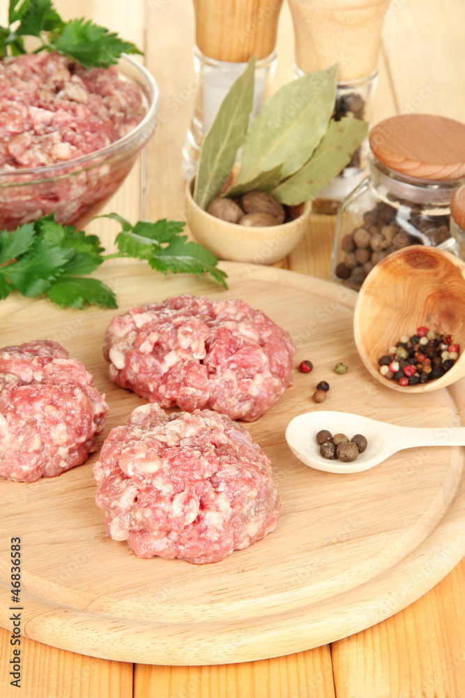 Raw meatballs with spices on wooden table Raw meatballs with spices on wooden table