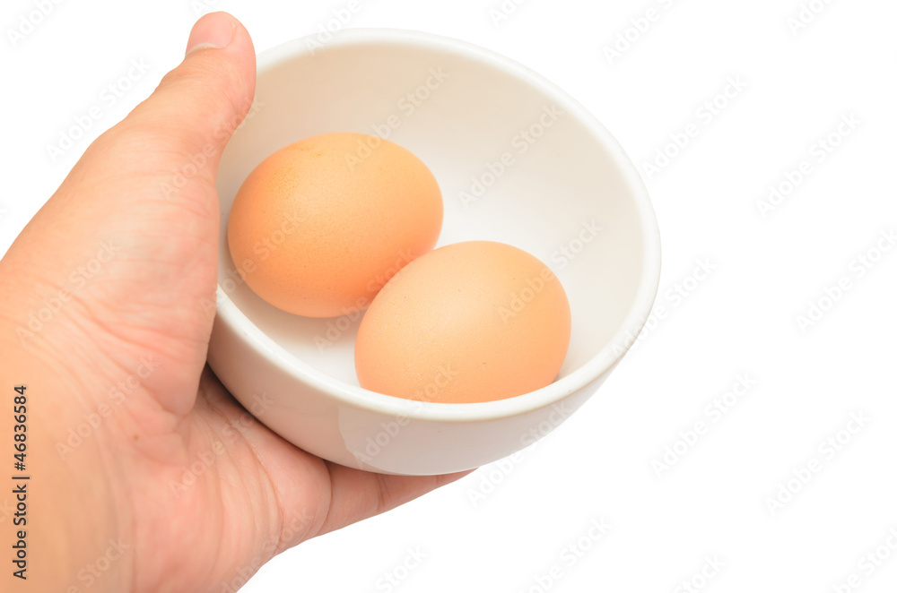 Hand bring Eggs in a cup isolated on white background Hand bring Eggs in a cup isolated on white background