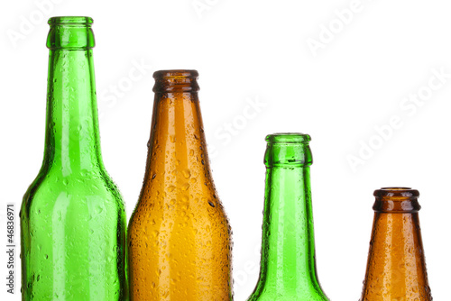 Colorful empty glass bottles isolated on white