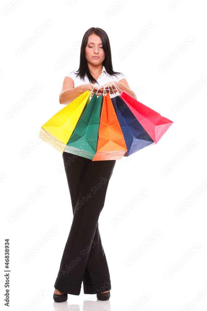 Portrait of young woman carrying shopping bags against white bac Portrait of young woman carrying shopping bags against white bac
