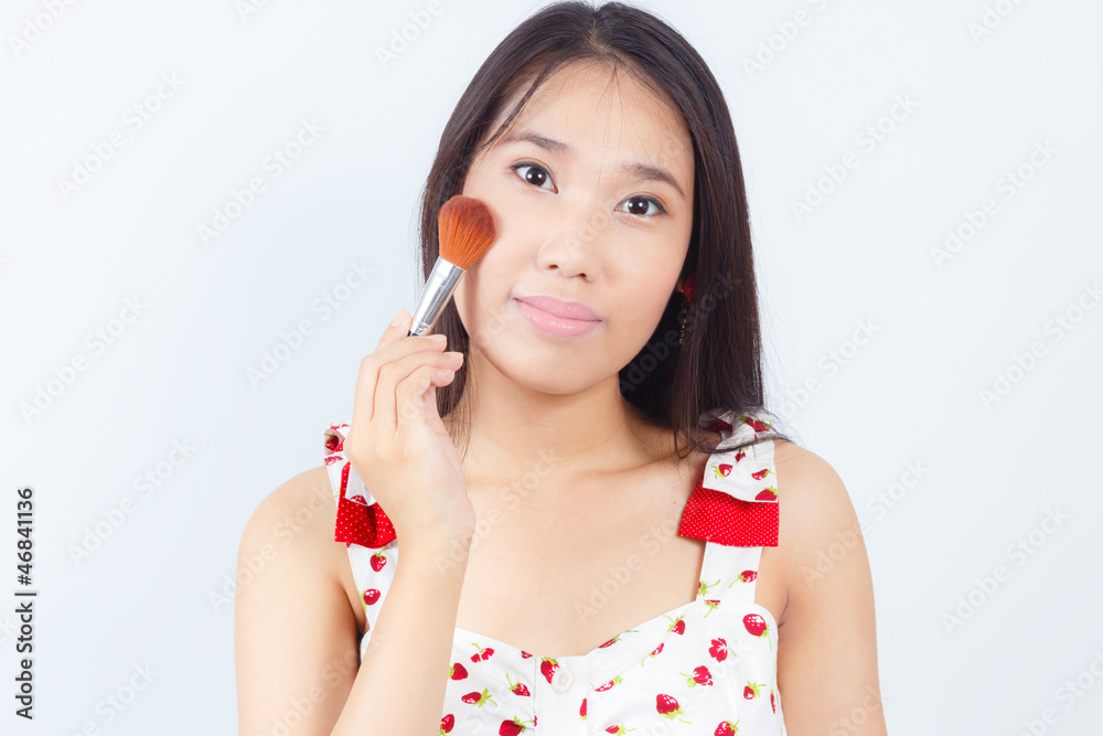 Portrait of Asian women attractive applying blusher Portrait of Asian women attractive applying blusher