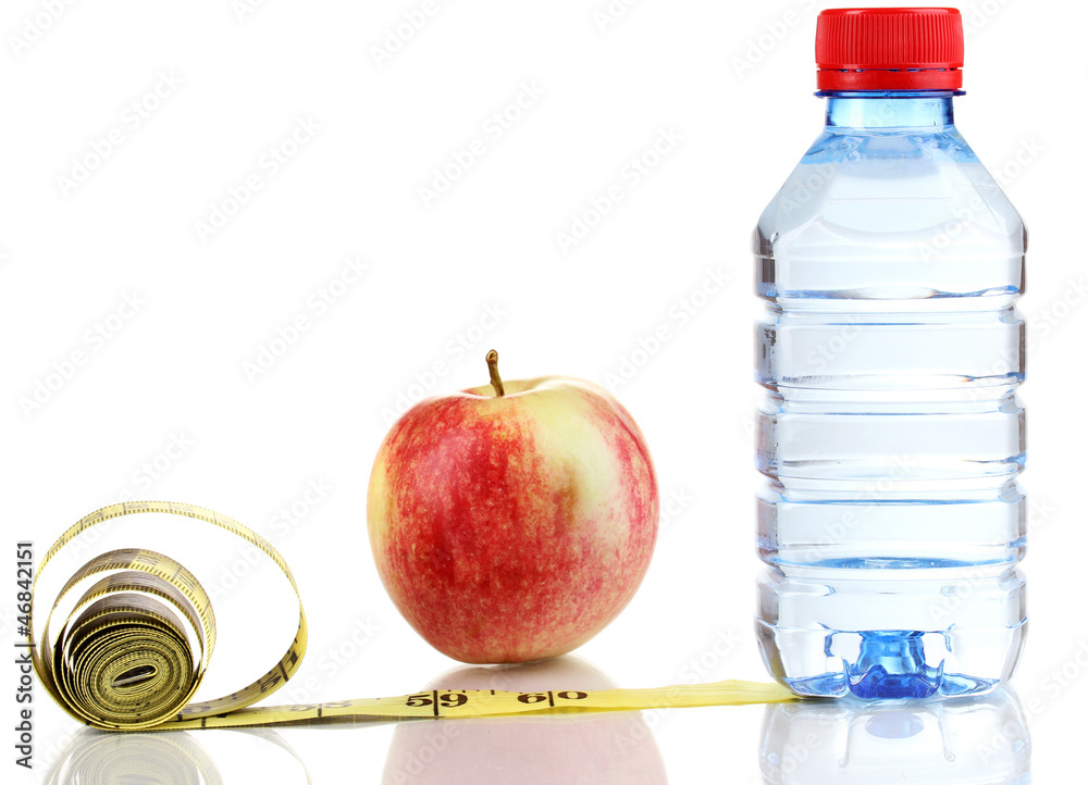 Fototapeta premium Healthy lifestyle with fresh apple, bottled water, and measuring tape for diet and fitness goals