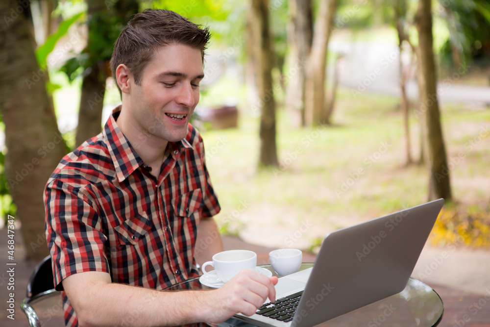Portrait of handsome young man working with laptop Portrait of handsome young man working with laptop