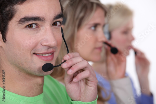 Young people with telephone headsets