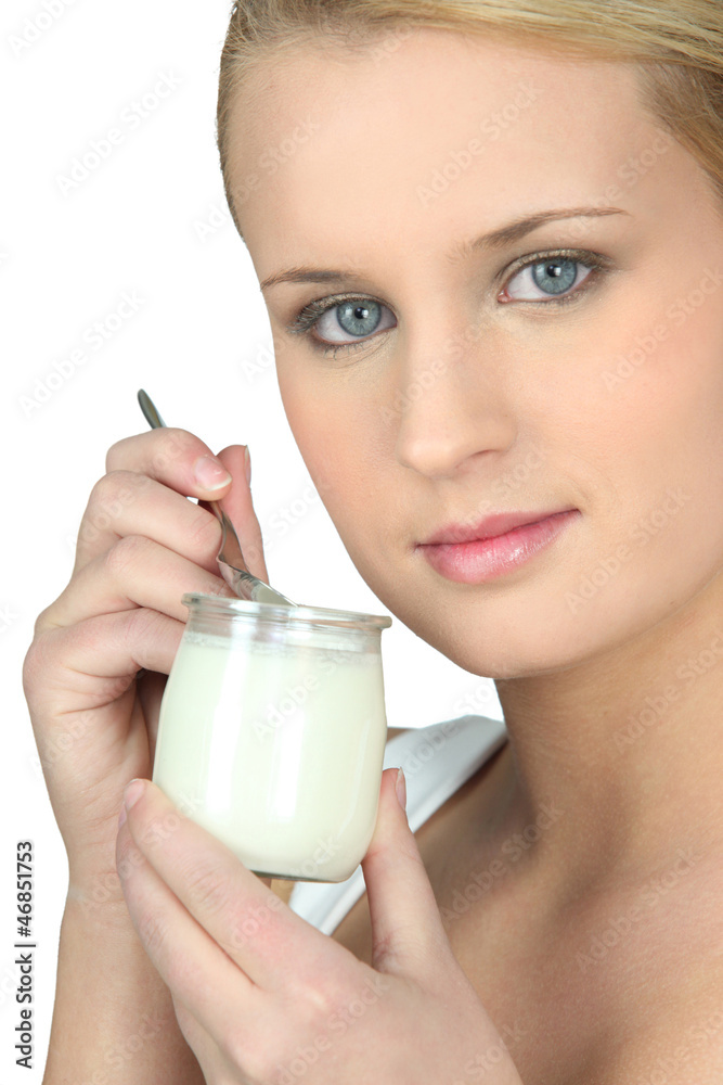 Young woman eating a yogurt Young woman eating a yogurt