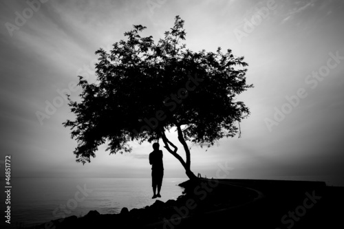 Silhourtte of Lonely man hanging his body under the tree