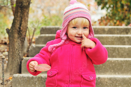 toddler girl pointing her nose