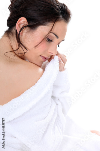 Relaxed brown-haired woman wearing bathrobe