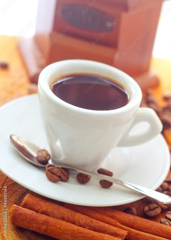 Fresh aroma coffee in the white cup, coffee and cinnamon Fresh aroma coffee in the white cup, coffee and cinnamon