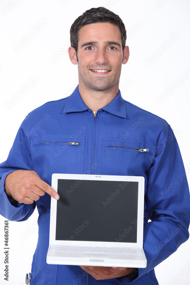 Manual worker pointing to laptop