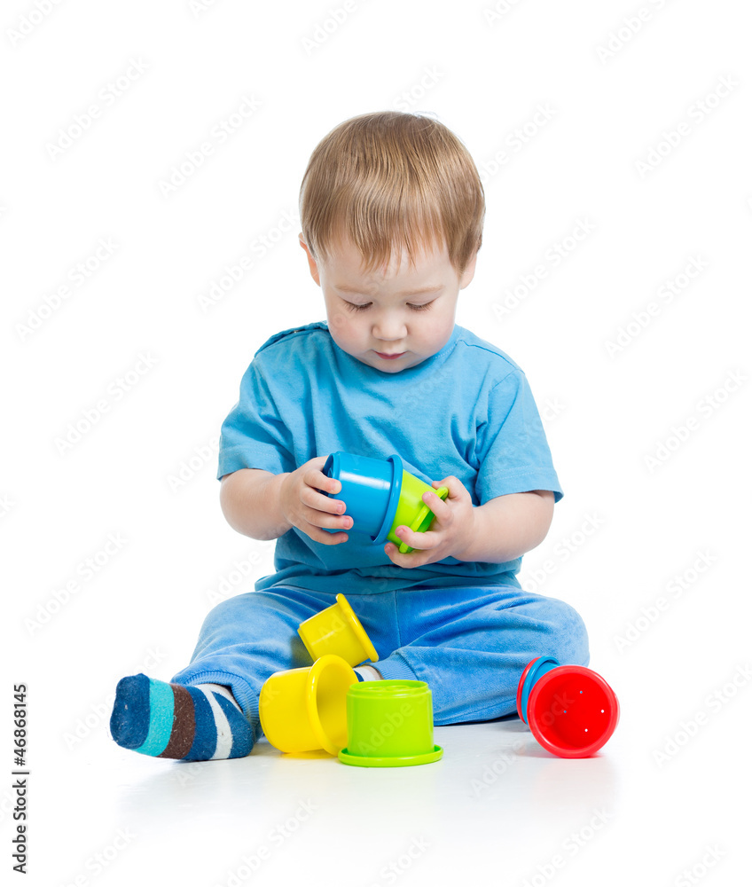 baby playing with colourful cup toys on floor, isolated over whi baby playing with colourful cup toys on floor, isolated over whi