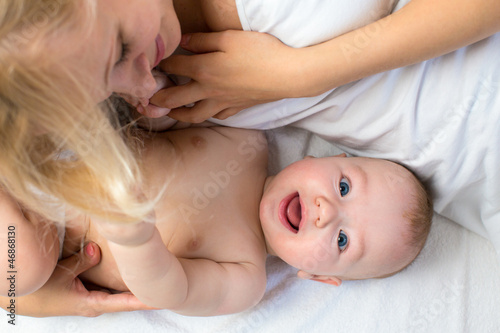 happy mother lying with bab...