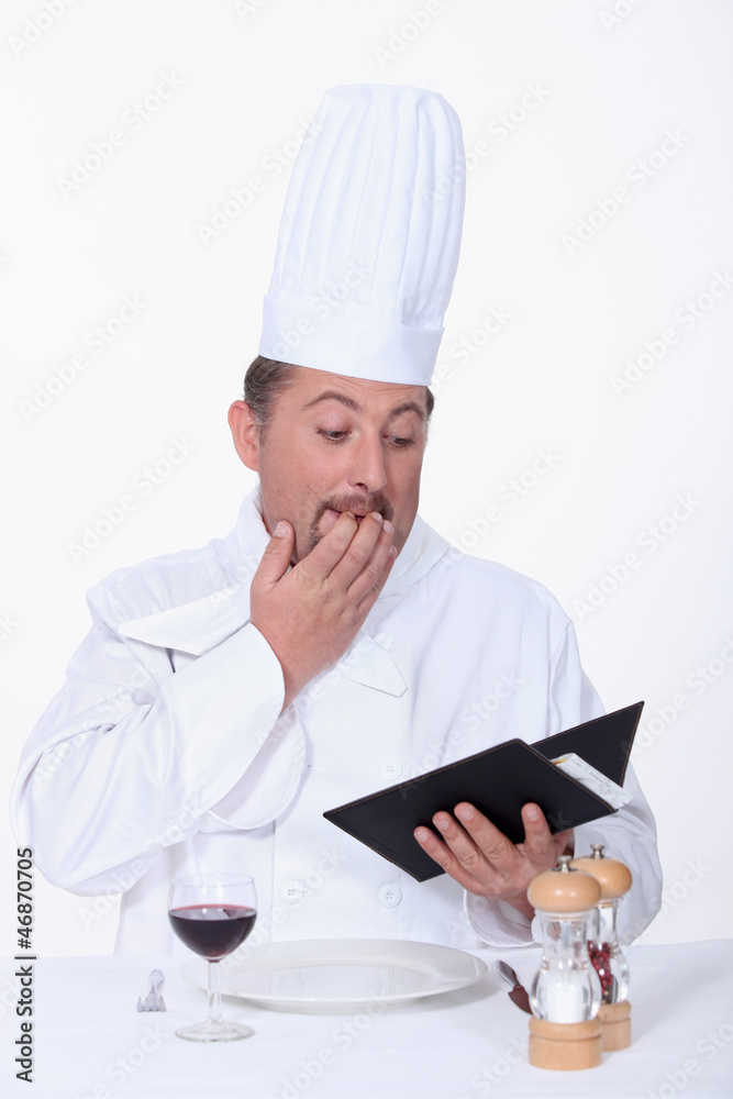 Restaurant worker looking through accounts Restaurant worker looking through accounts