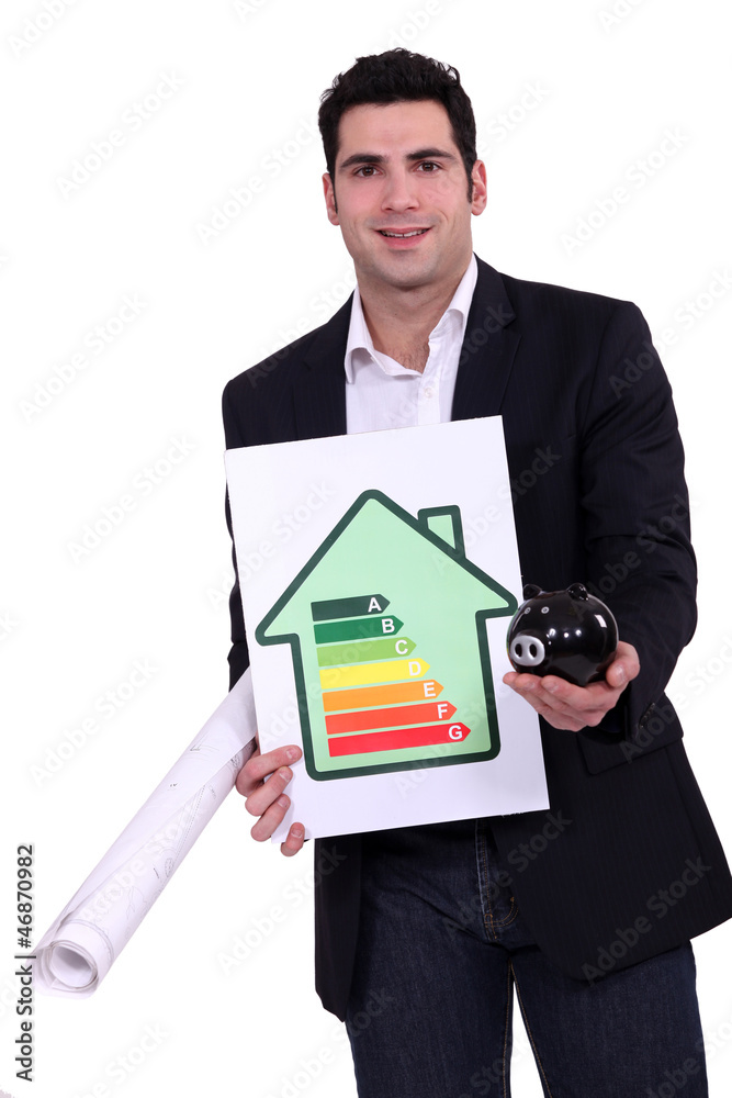 Man with energy rating sign and piggy bank Man with energy rating sign and piggy bank