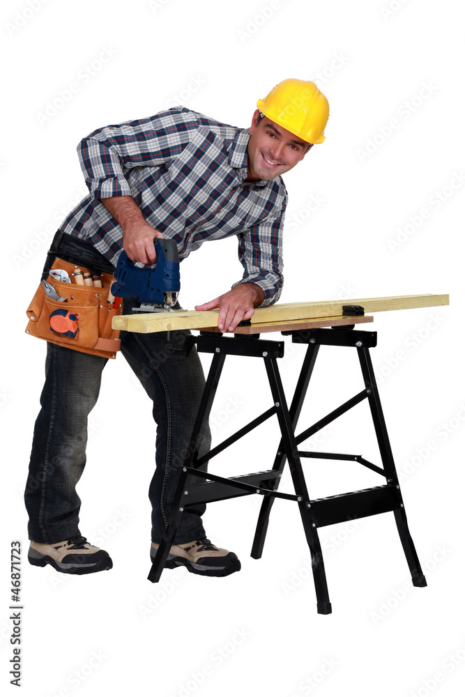 A man using a jigsaw A man using a jigsaw