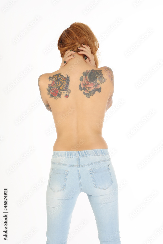 Beautiful woman with tattoos on back and blue jeans Beautiful woman with tattoos on back and blue jeans