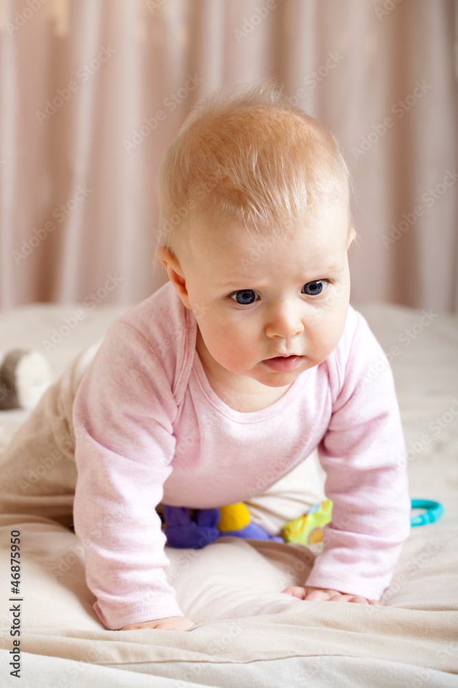 Portrait of curious baby girl crawling on bed, closeup shot Portrait of curious baby girl crawling on bed, closeup shot