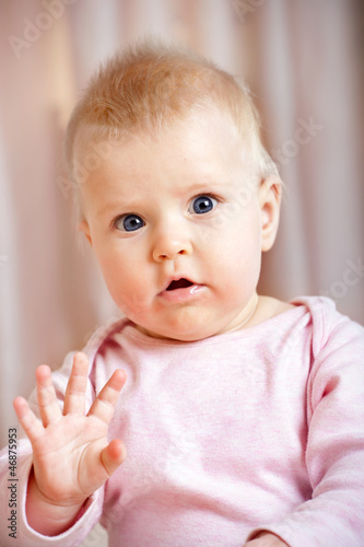 Cute baby girl waving hello/goodbye
