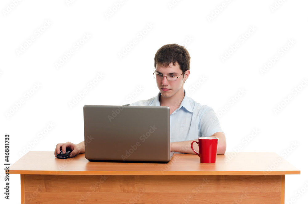 The businessman behind a table with the computer The businessman behind a table with the computer