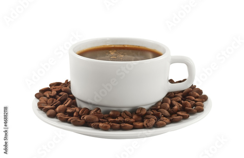 White cup of coffee with coffee beans on a plate
