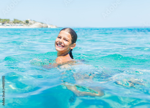 Young girl playing in the sea