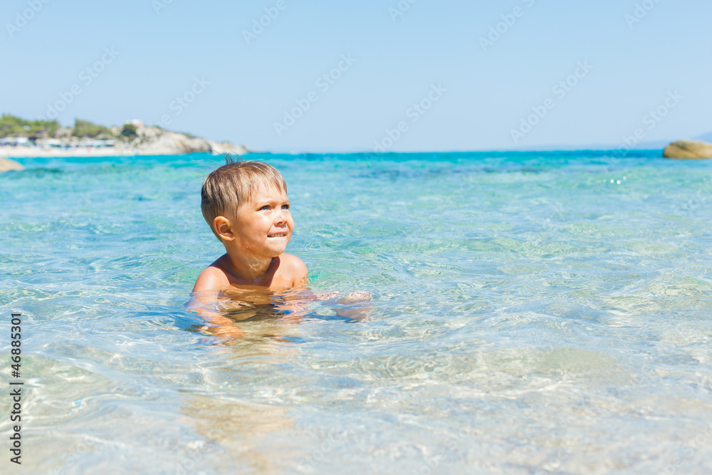 Cute boy playing in the sea Cute boy playing in the sea
