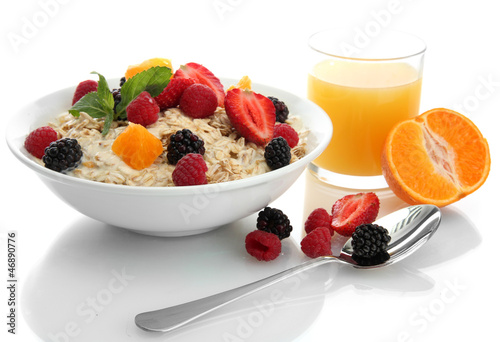 tasty oatmeal with berries and glass of juice, isolated on