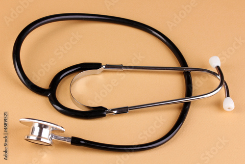 Stethoscope on beige background