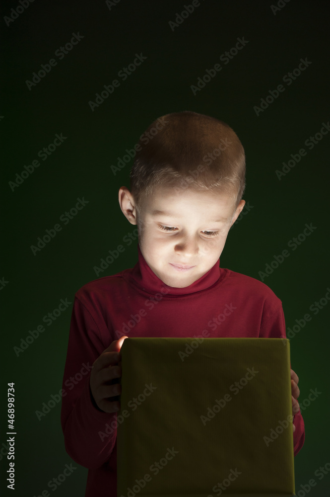 boy with present, light coming out of the box boy with present, light coming out of the box