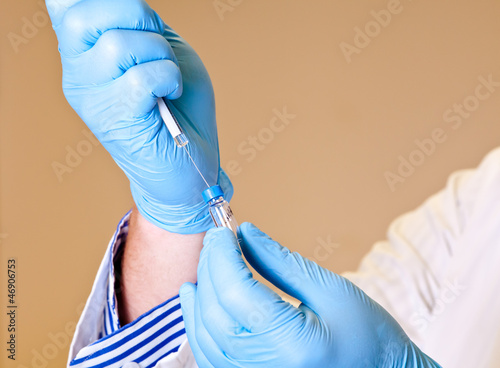 Scientist holds syringe for laboratory analysis photo