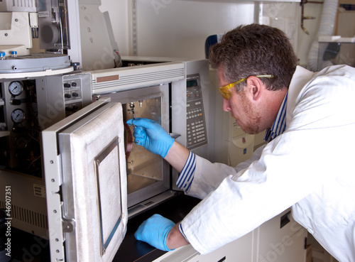 Obraz na płótnie Scientist prepares chromatograph oven installing column