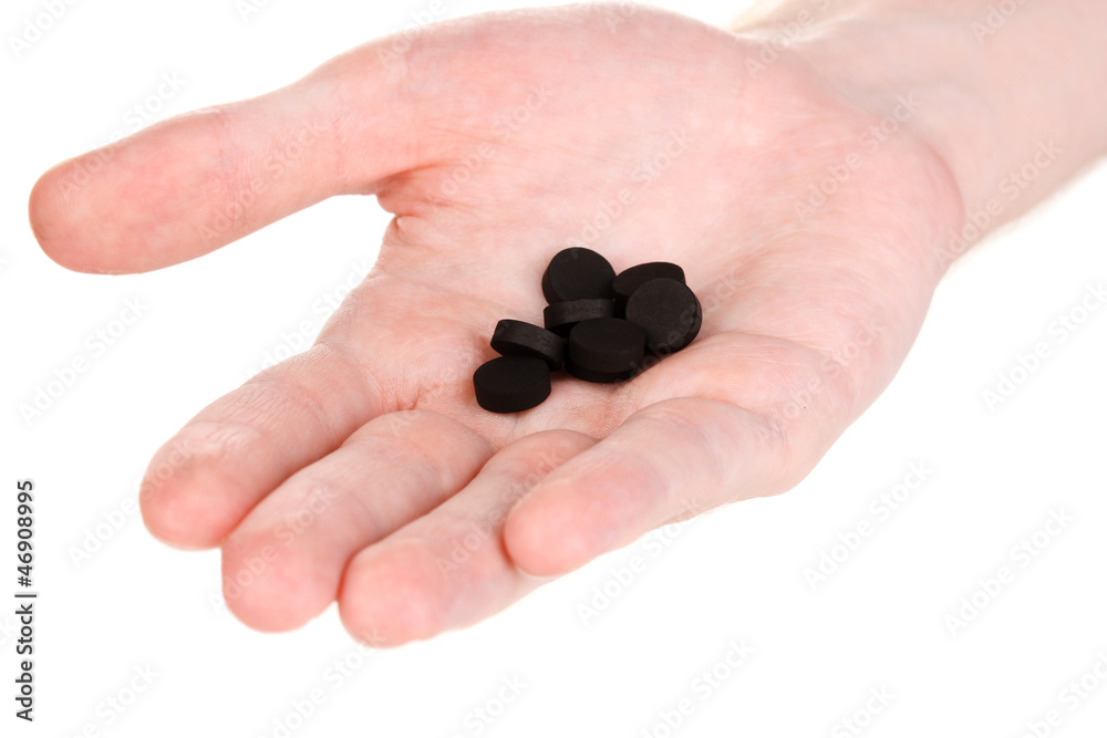 activated carbon in hand isolated on white activated carbon in hand isolated on white