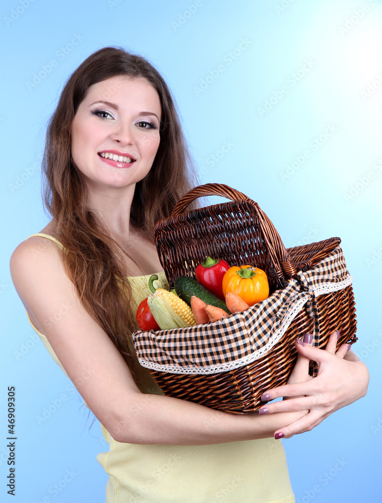 Beautiful woman with vegetables in wicker basket Beautiful woman with vegetables in wicker basket