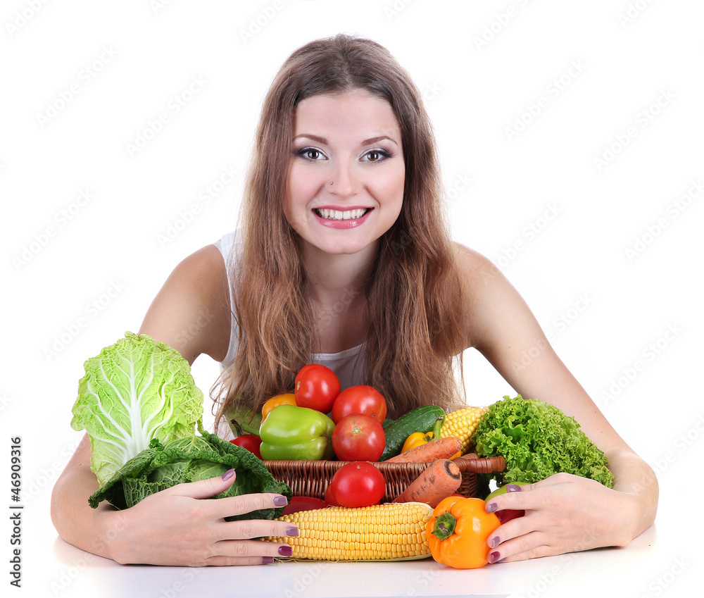 Beautiful woman with vegetables on table isolated on white Beautiful woman with vegetables on table isolated on white
