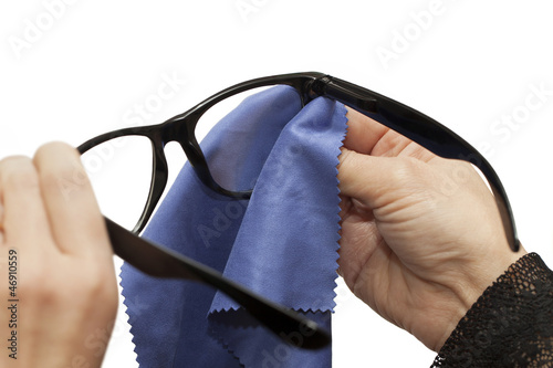 Woman trying to clean spectacles on a white background
