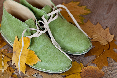 Obraz na plátně green leather boots and yellow leaves