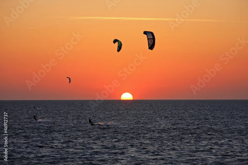 kitesurfers at sunset